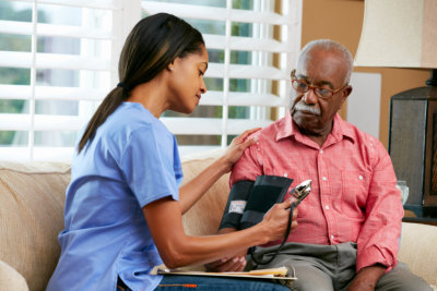 lady nurse getting the old man's blood pressure