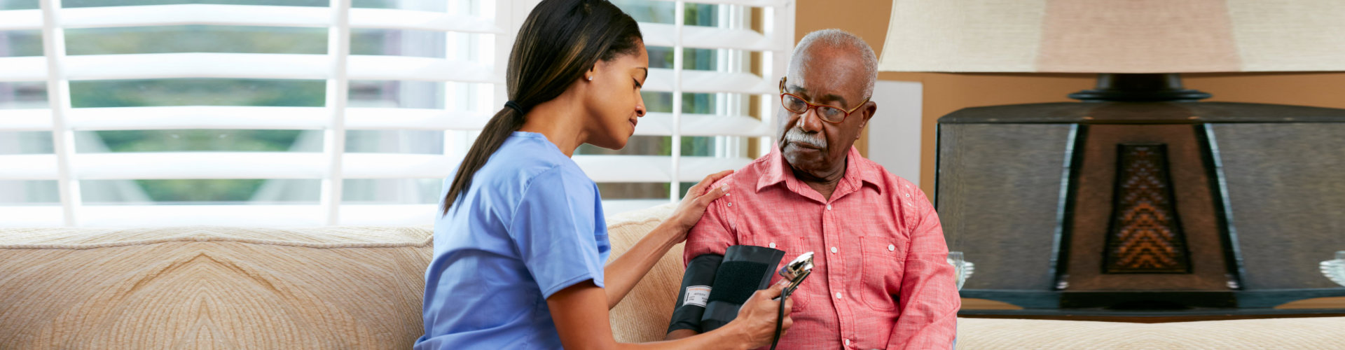 lady nurse getting the old man's blood pressure