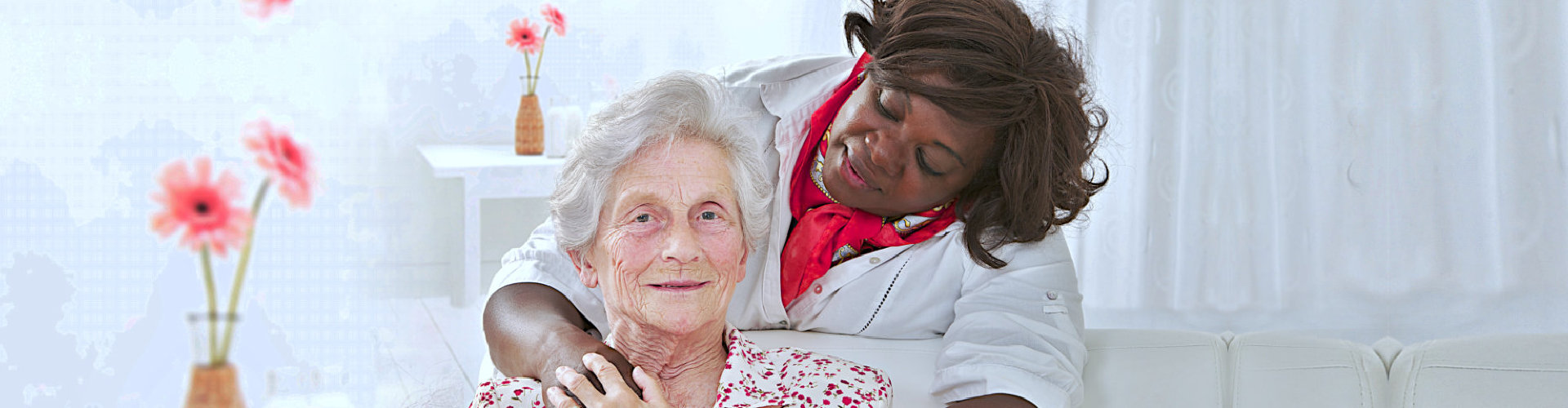 old lady smiling while her caregiver watching